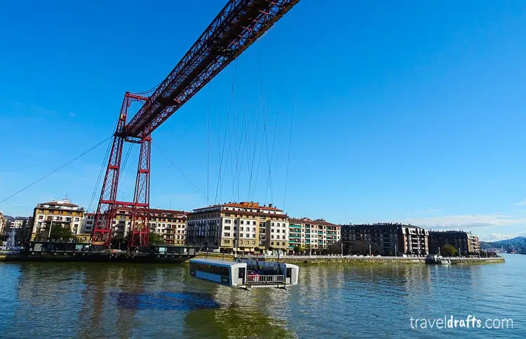 The Vizcaya Bridge near Bilbao, a unique transporter bridge with a gondola that carries passengers and vehicles across the river, exemplifying the city's industrial ingenuity.