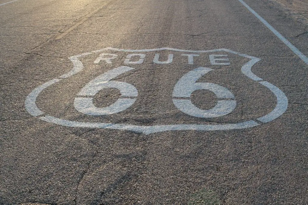 Route 66 written in white paint on a road