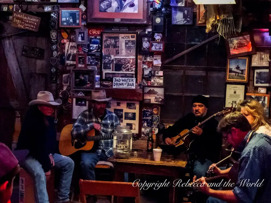 Five musicians strum guitars during a jam session at Luckenbach, Texas