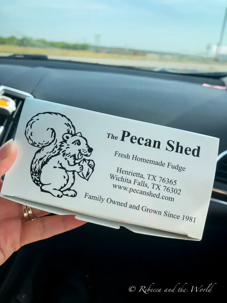 A close-up of a box of fresh homemade fudge from The Pecan Shed, indicating the product is made in Henrietta and Wichita Falls, Texas, with the company's squirrel logo. On your way to visit Amarillo, stop by the Pecan Shed for the best fudge you'll ever eat!