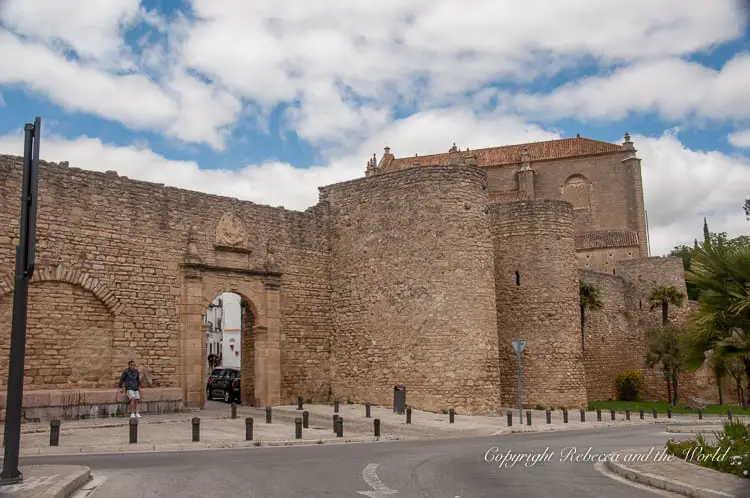 The ancient walls and gateway of Ronda, displaying the formidable stone fortifications that characterise much of the town's old quarter.