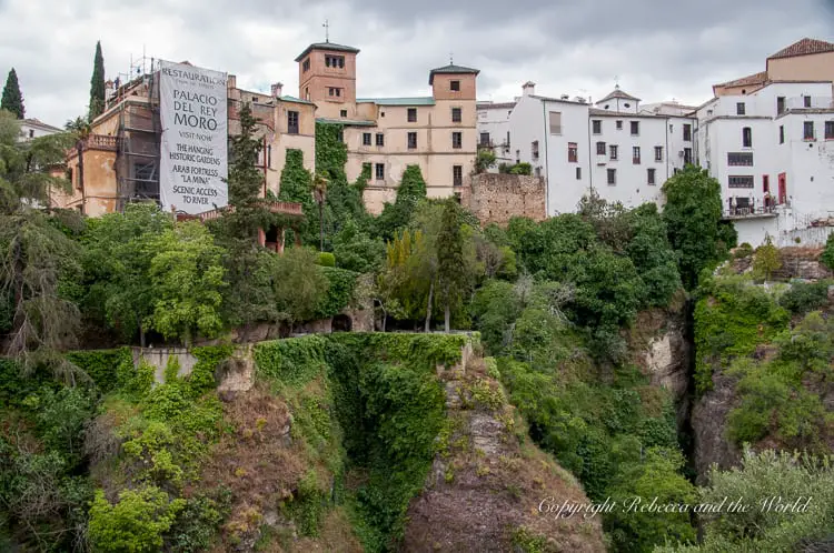 A view of the historical Palacio del Rey Moro and its gardens, nestled on the edge of the gorge, highlighting Ronda's unique blend of nature and history.