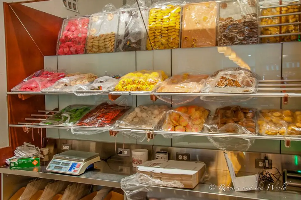 Shelves stocked with a variety of packaged cookies and candies in clear and colorful wrappings. Modern Pasty in Boston's North End is famous for its cannoli.