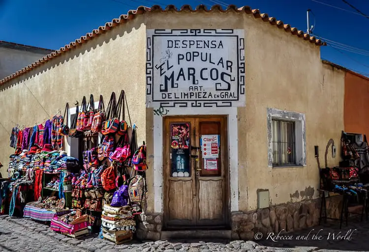 A yellow rendered shop in Northwest Argentina displays colourful bags and rugs outside. The small towns in Northwest Argentina are very different to the rest of the country.
