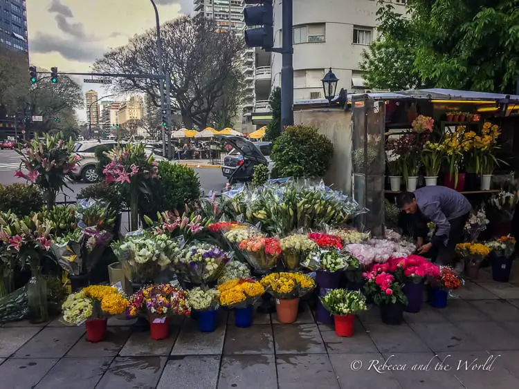 Bunches of colourful flowers in buckets on a street corner in Buenos Aires