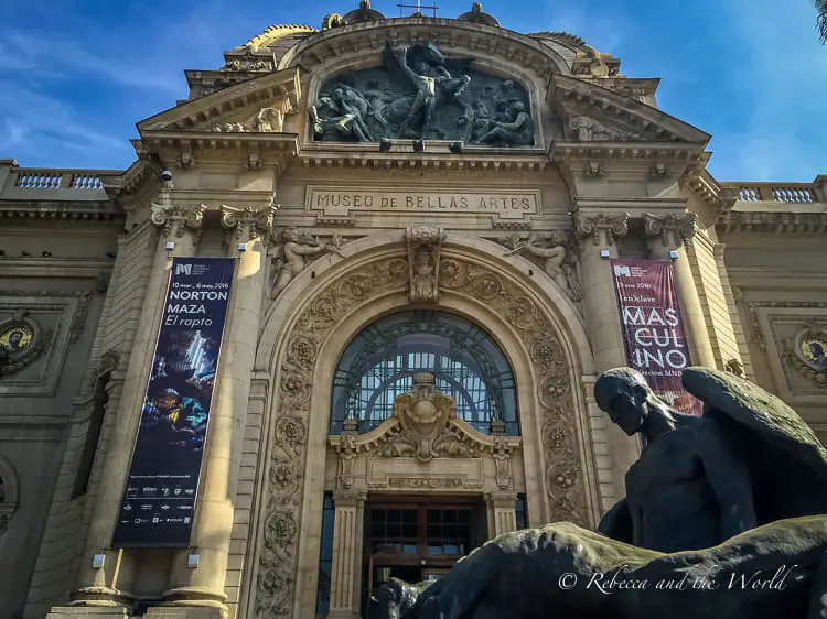 The ornate facade of the "Museo de Bellas Artes" in Santiago Chile with sculptures and detailed architectural embellishments, under a clear blue sky.