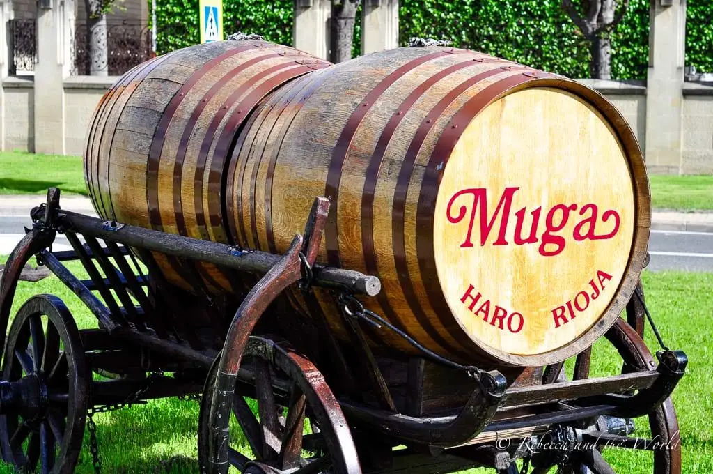 A traditional wooden wine barrel on a cart, labeled with 'Muga, Haro, Rioja', representing one of La Rioja's renowned wineries. Bodegas Muga is one of the best wineries in La Rioja and easy to visit.