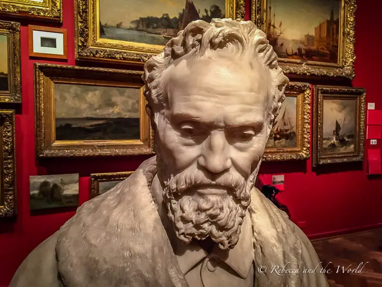 Close-up of a detailed sculpture of a bearded man's bust, possibly representing a figure of Argentine cultural significance, displayed in a Buenos Aires museum. The Museo Nacional de Bellas Artes features works from Latin American artists as well as the European masters.