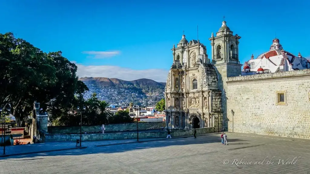 The facade of a church in Oaxaca with clear blue sky in the background. Oaxaca is a beautiful city, and one of the best places to visit in Mexico - this guide shares everything you need to know before travelling to Oaxaca.