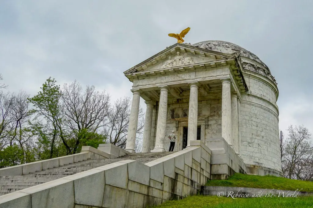 Illinois Monument at Vicksburg National Military Park, featuring a grand domed structure with classical columns and a golden eagle on top, amidst green trees. There are many sights to see at the Vicksburg National Military Park.