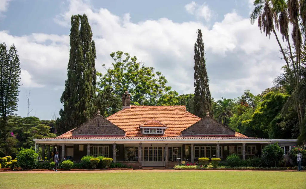 A long, low building with red tiled roof, this is the front of the Karen Blixen Museum, a popular place to visit in Kenya
