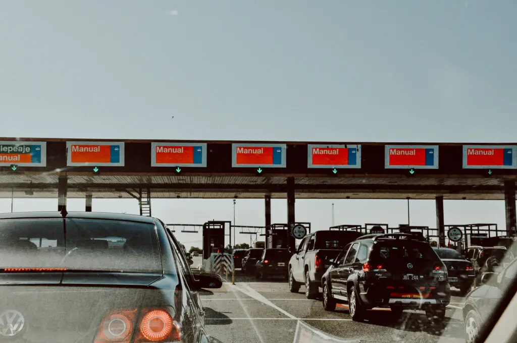 Cars line up to go through a toll booth in Argentina