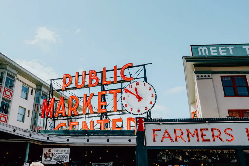 A red neon sign says Public Market Center at Pike Place Market in Seattle, Washington