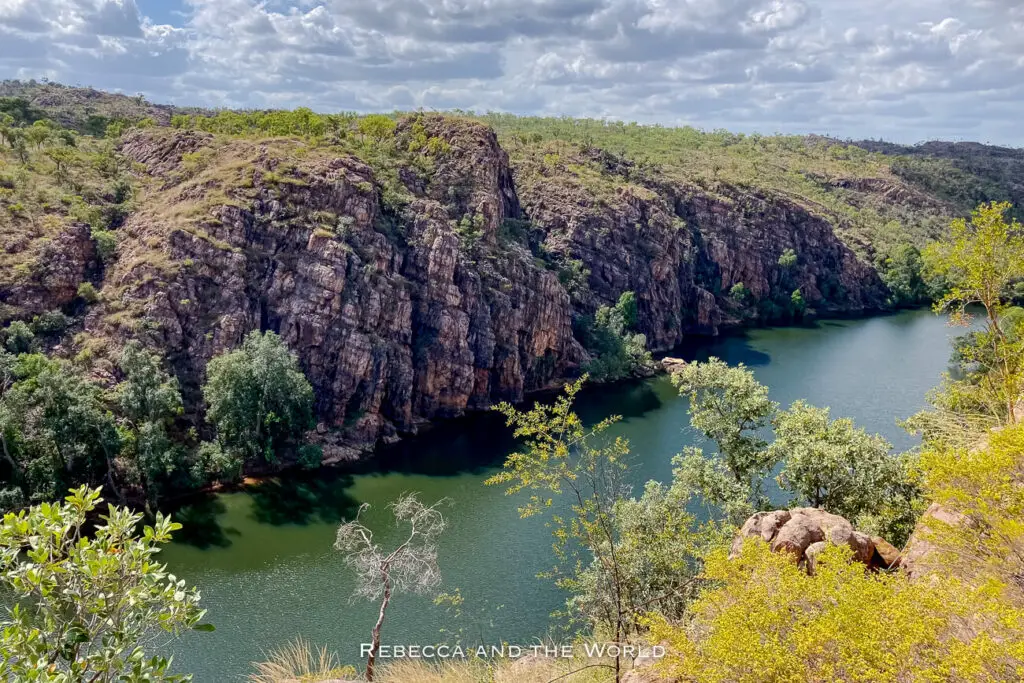 A breathtaking view over Nitmiluk Gorge - or Katherine Gorge, as some still call it - with the Katherine River running through it, surrounded by rugged cliffs and lush greenery.