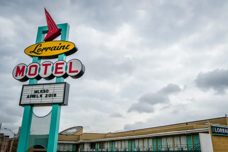 The iconic sign of the Lorraine Motel, featuring a bright neon design with a red arrow. The marquee displays "MLK50 April 4, 2018". The motel facade appears in the background. One of the best things to do in Memphis is visit the Civil Rights Museum.