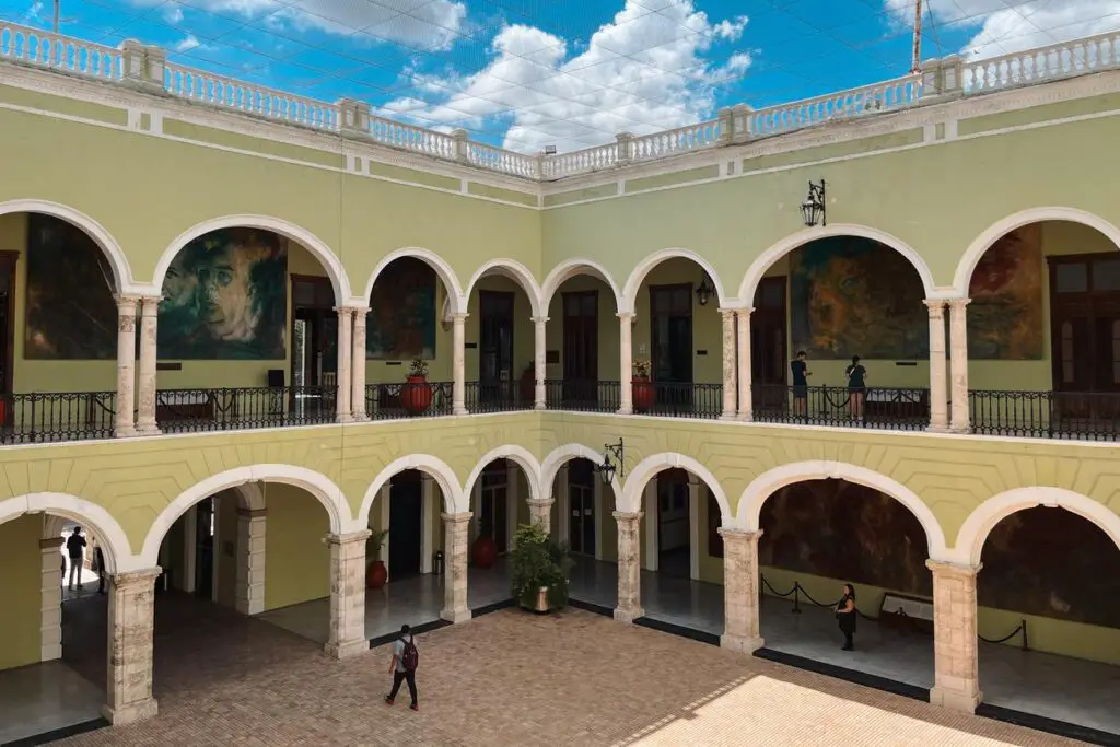 Interior courtyard of Merida’s Palacio de Gobierno, with colonial arches and murals depicting Yucatan’s history.