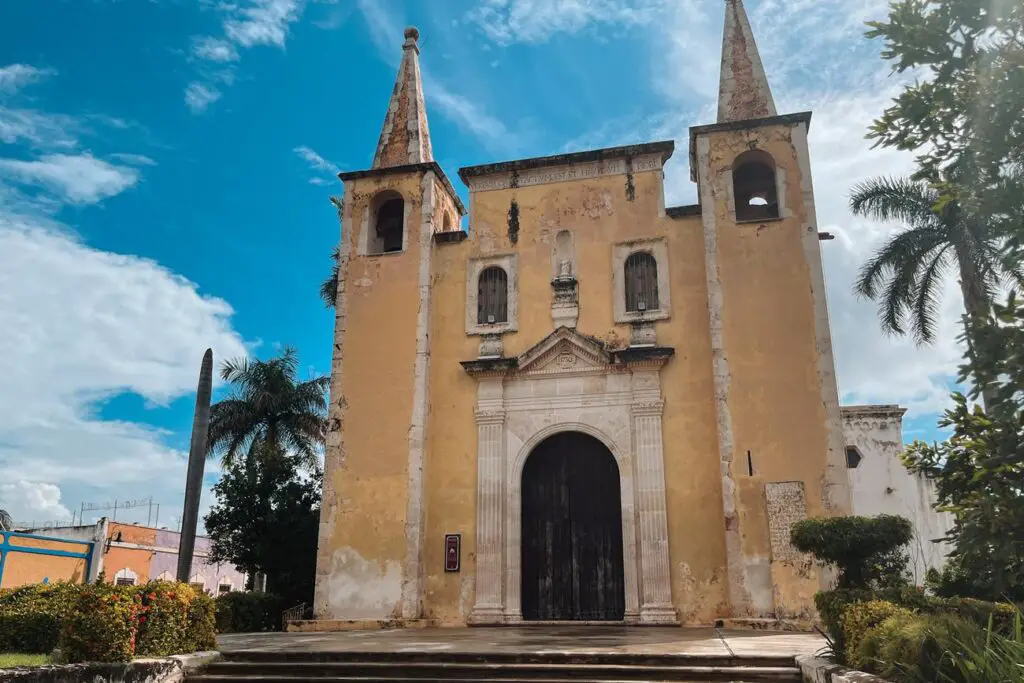 Historic yellow church in Merida, showcasing colonial architecture common across Merida and nearby villages.
