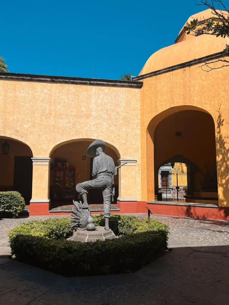 A bronze statue of a jimador harvesting agave, located in the courtyard of the Jose Cuervo distillery in Tequila, Mexico—highlighting the deep cultural roots of tequila production.
