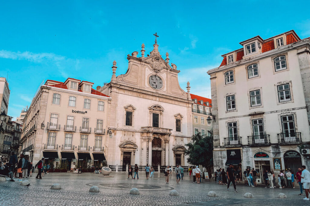 Church of São Roque and surrounding square with people walking and relaxing – a historical and cultural site worth visiting during your 2 days in Lisbon.