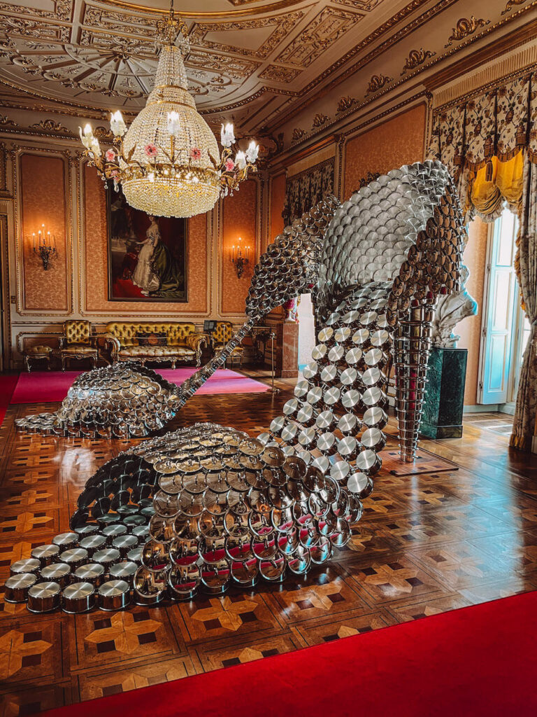 Contemporary art installation made from shiny metal pots displayed in a historic palace room in Madrid – a unique sight for a weekend in Madrid. Liria Palace is a must-visit.