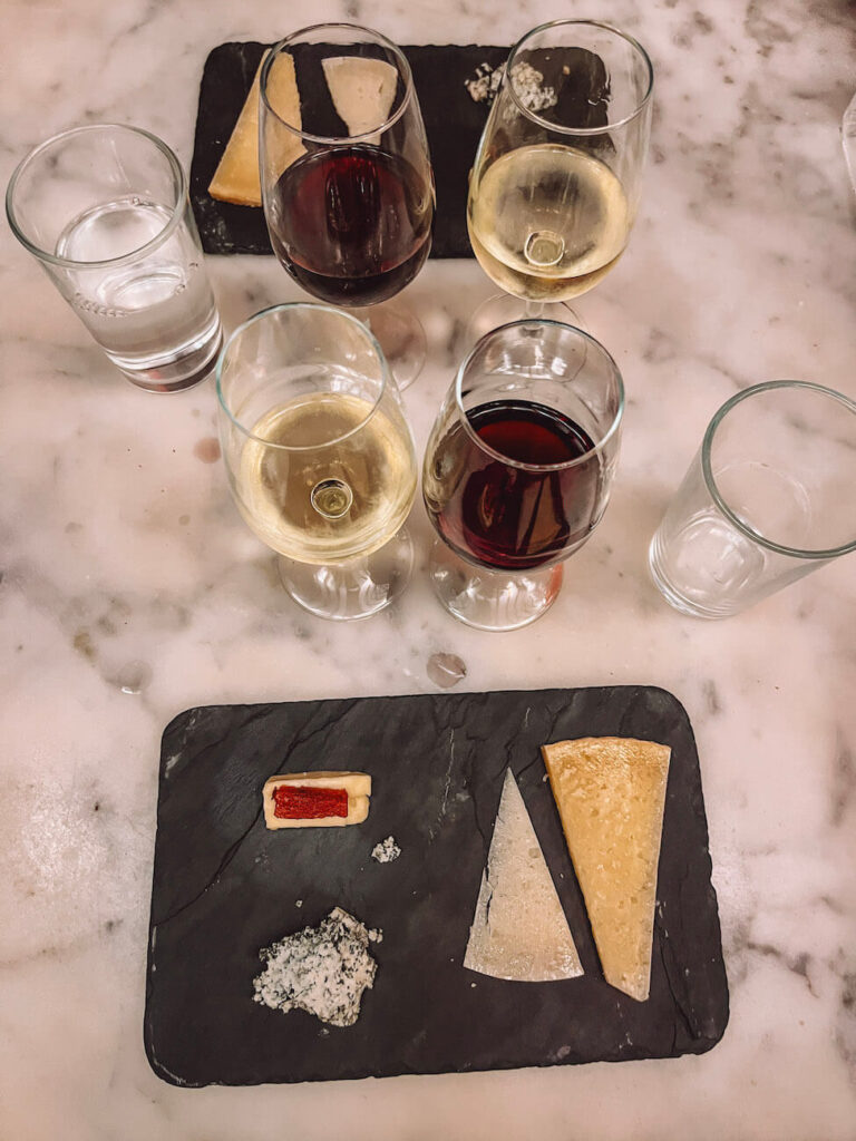 Spanish wine and cheese tasting with red and white wines paired with regional cheeses – a delicious foodie experience to enjoy on a 2-day Madrid itinerary. A Madrid food tour with Devour Tours is a must!