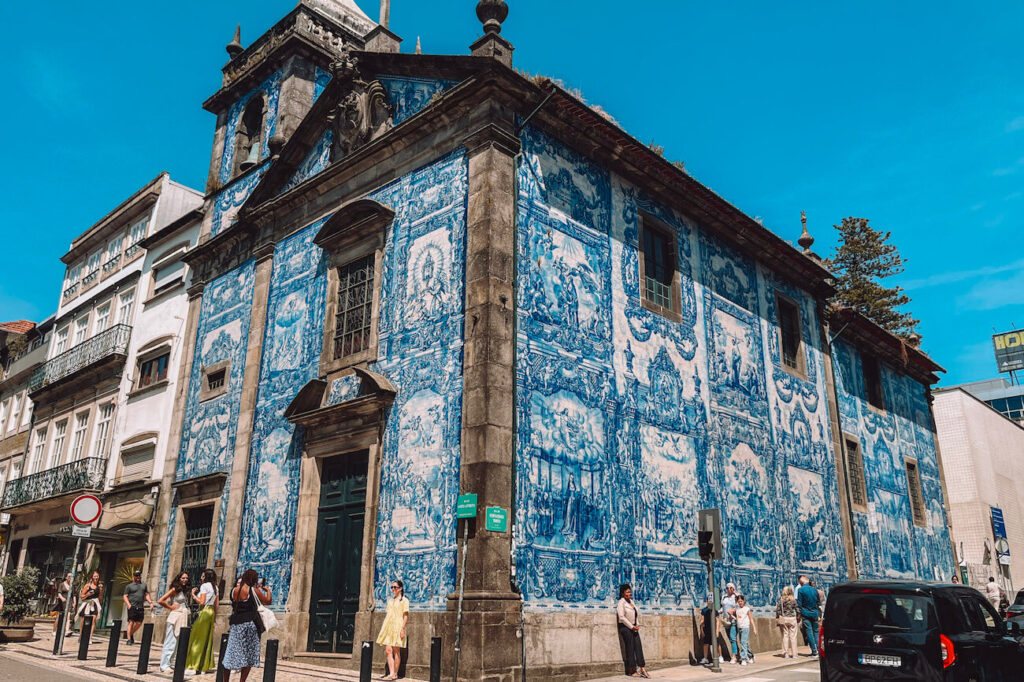 Exterior of the Chapel of Souls in Porto, covered in traditional blue and white azulejo tiles depicting religious scenes – a must-see on any 2-day Porto itinerary.