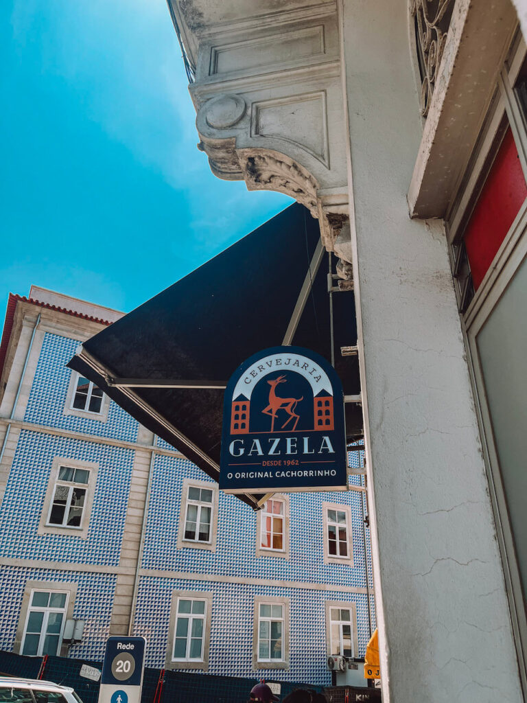 Hanging sign for Cervejaria Gazela, home of the original "cachorrinho" hot dog – a popular food stop to include in your Porto itinerary.