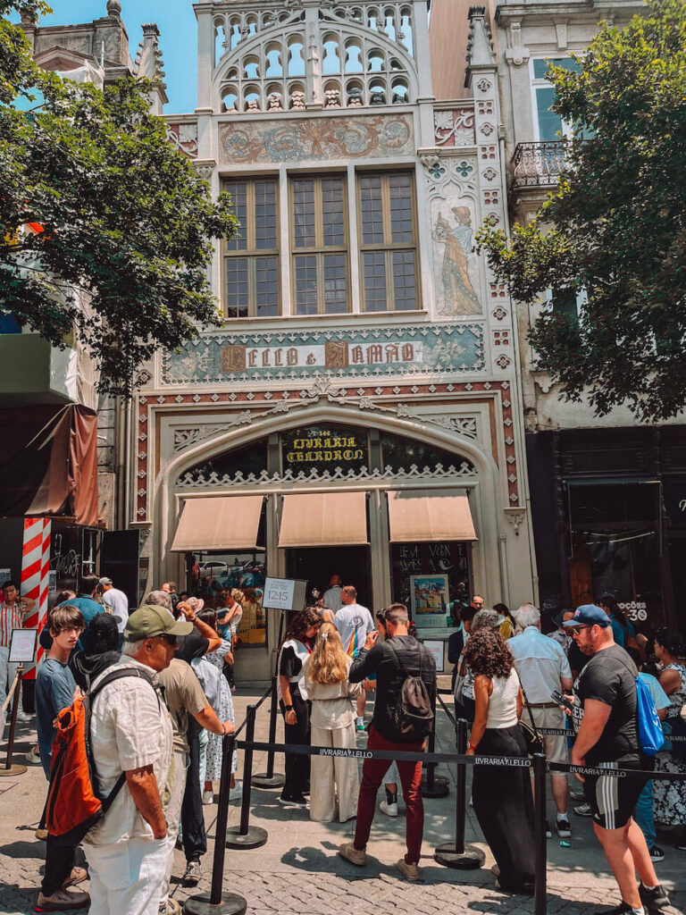 Crowd of visitors queued outside the iconic Livraria Lello bookstore in Porto – if you want to see this beautiful bookshop in Porto, Portugal, be prepared to line up!