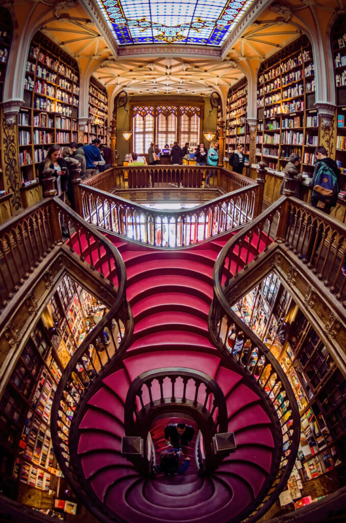 Interior view of Livraria Lello, showing its famous red staircase and stained glass ceiling – a stunning stop for book lovers on a 2-day Porto itinerary.