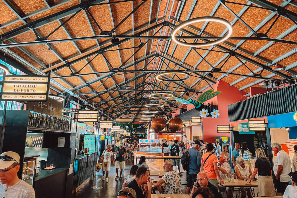 Interior of Mercado Beira-Rio in Porto, a bustling food market with modern lighting and a variety of food stalls – a lively place to eat during a 2-day Porto itinerary.