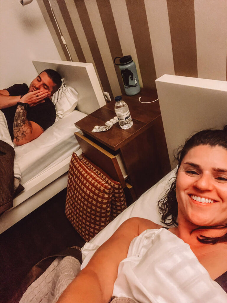 A relaxed moment in a twin room shows two pilgrims - the author and her husband - resting in bed.