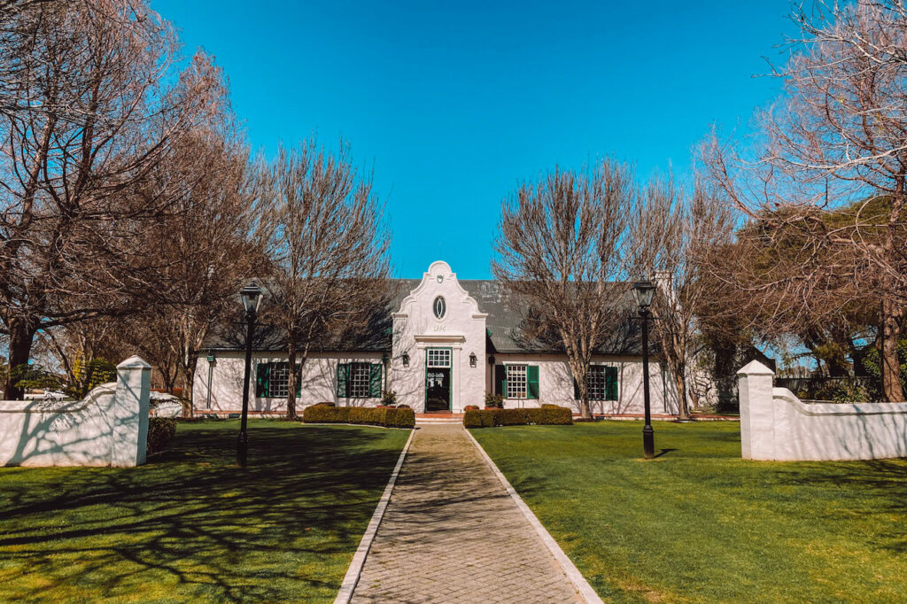 Winery estate with manicured gardens and a white heritage-style building in Margaret River – ideal for wine tasting during 2 weeks in Australia.