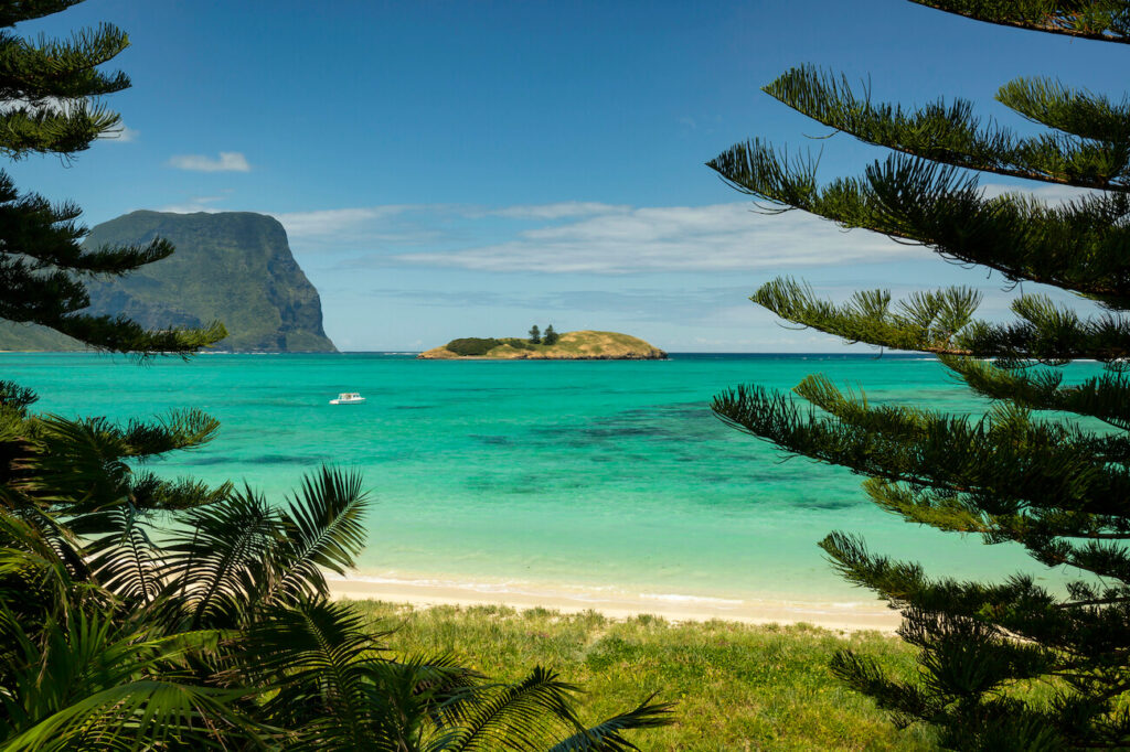 View of Lord Howe Island’s emerald waters and dramatic peaks, the perfect setting for a luxury honeymoon in Australia away from the crowds.