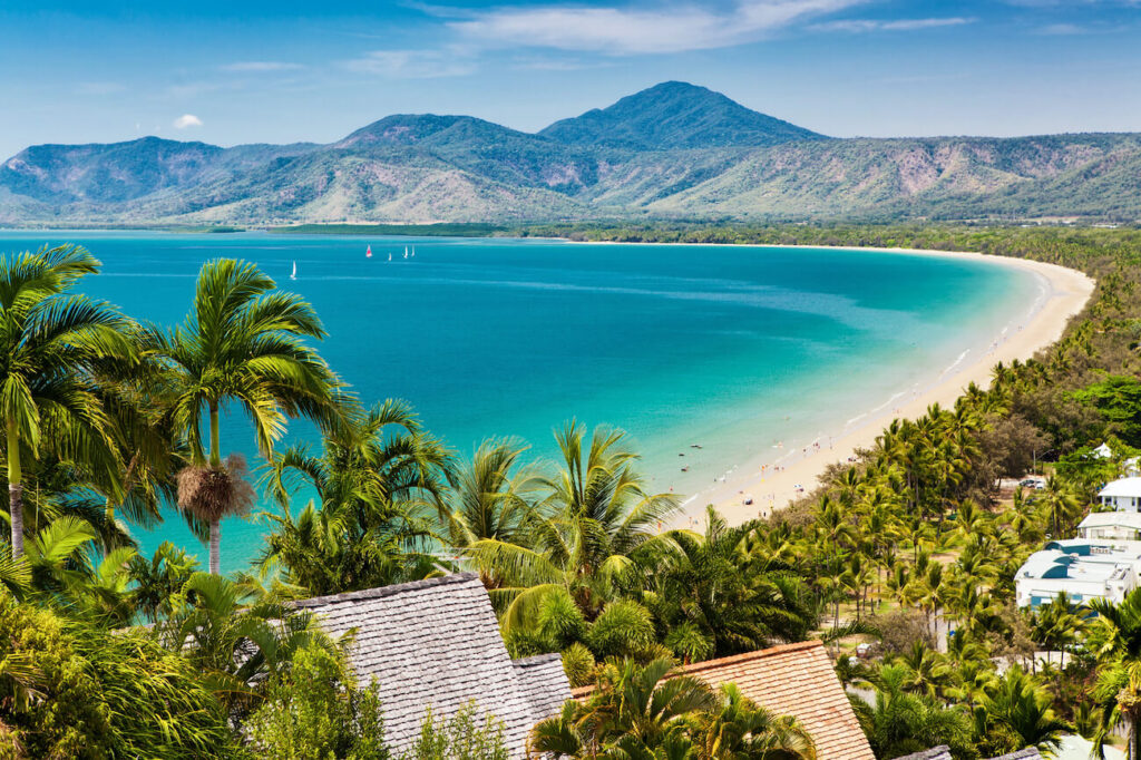 Aerial view of palm-lined Four Mile Beach in Port Douglas — one of the most romantic places to honeymoon in Australia, combining reef and rainforest adventures.
