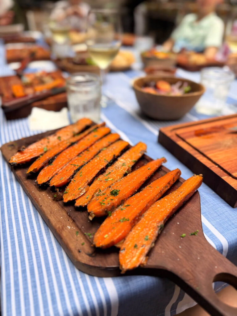 Charred, herb-seasoned carrots served as a side dish during the Asado Adventure, highlighting the variety beyond meat at this asado tour in Buenos Aires.