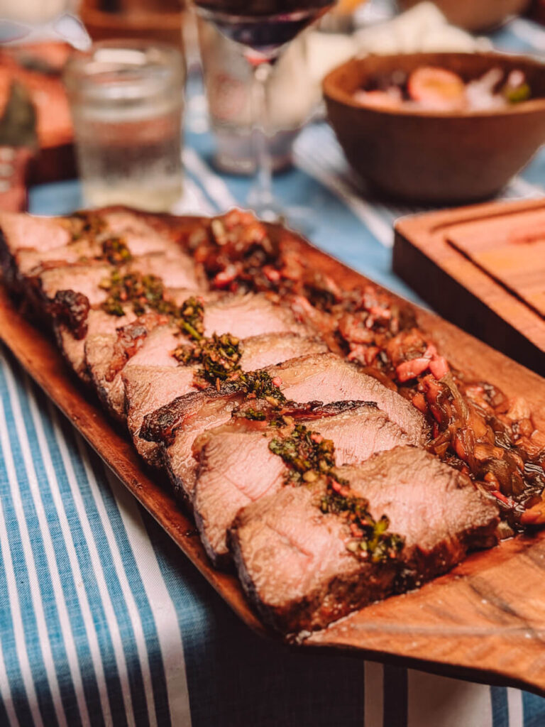 Perfectly cooked slices of beef served with chimichurri at Asado Adventure, a standout Argentine barbecue dish on this asado tour in Buenos Aires.