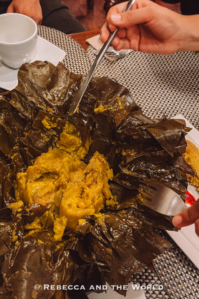 Large banana leaf unwrapped to reveal a traditional Colombian tamal filled with meat and corn dough, a classic dish to try during 48 hours in Bogotá.