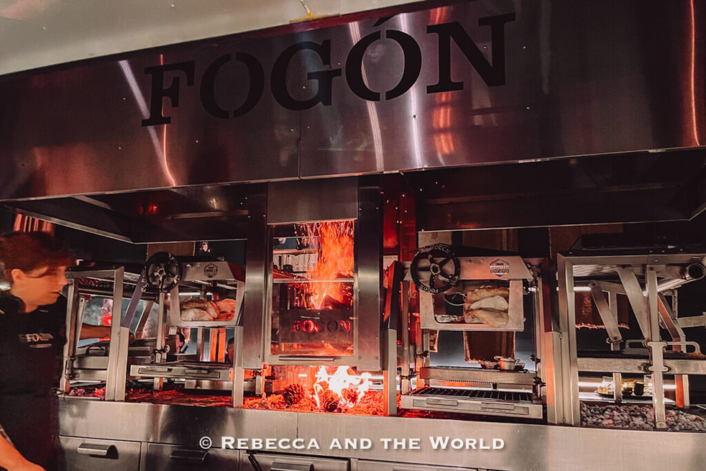 Open-fire grill and glowing embers inside the Fogon Asado kitchen in Buenos Aires, showcasing the live-fire cooking experience.
