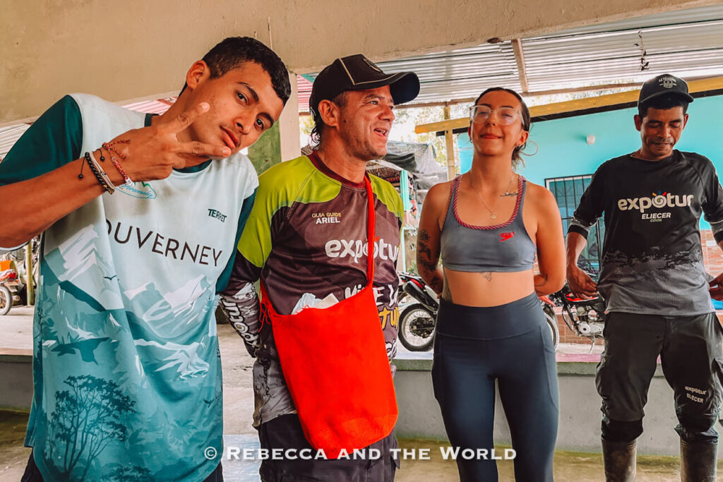Local guides from Expotur posing together during the Lost City trek, wearing hiking clothes and standing inside a rural shelter before the Ciudad Perdida hike.
