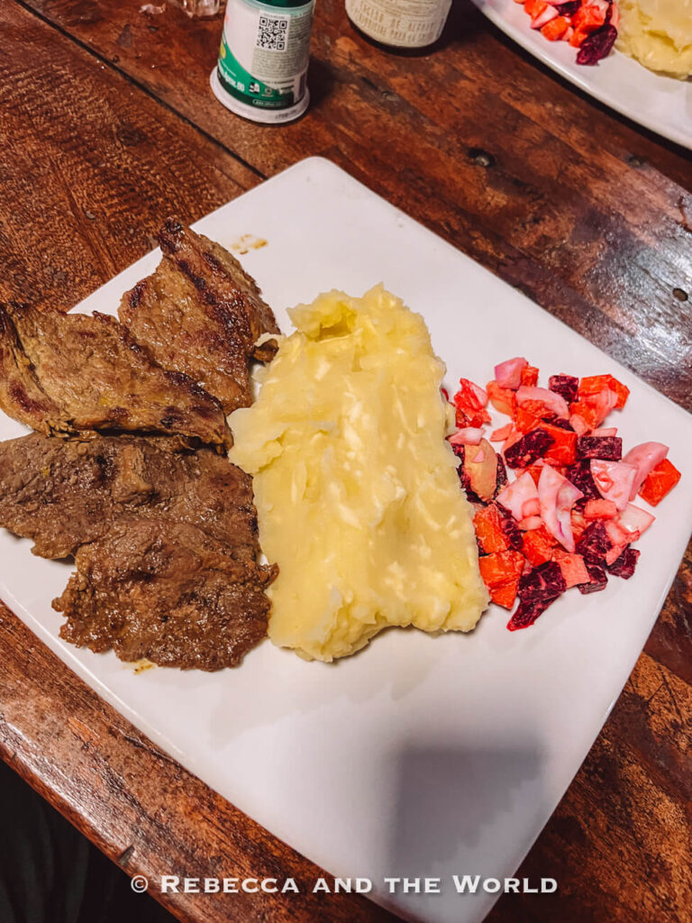 Plate of grilled meat, mashed potatoes, and beet salad served at a jungle camp during the Ciudad Perdida hike.
