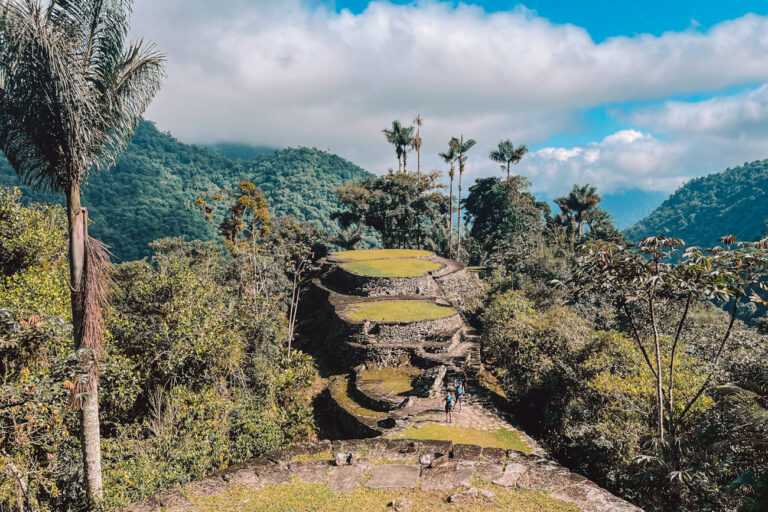 Ancient stone terraces of Ciudad Perdida surrounded by lush jungle and misty mountains during the Lost City trek in Colombia.