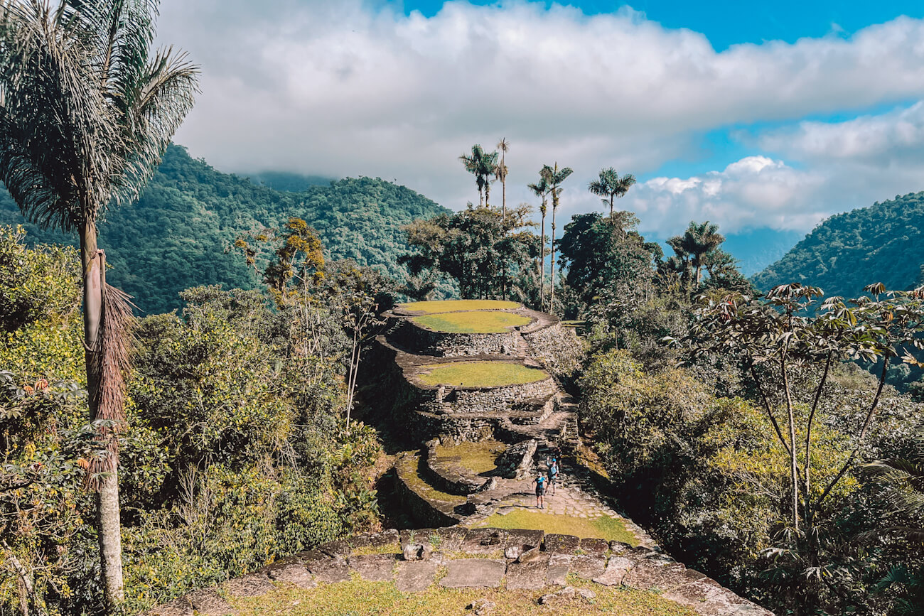 Ancient stone terraces of Ciudad Perdida surrounded by lush jungle and misty mountains during the Lost City trek in Colombia.