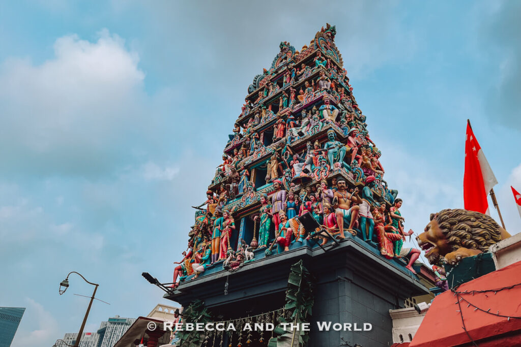 Ornately decorated entrance tower of Sri Mariamman Temple in Chinatown, covered with colourful sculptures of Hindu deities and mythological figures.