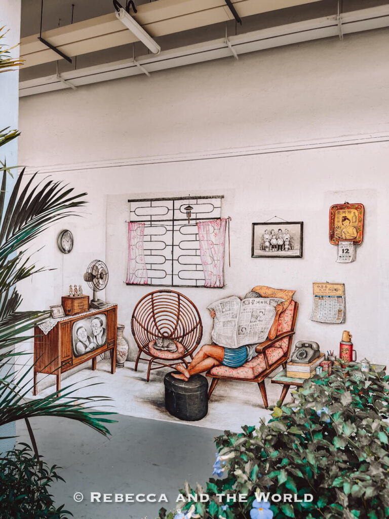 Nostalgic Tiong Bahru mural depicting a person reading a newspaper in a vintage living room with rattan furniture, an old television, telephone and wall calendars.