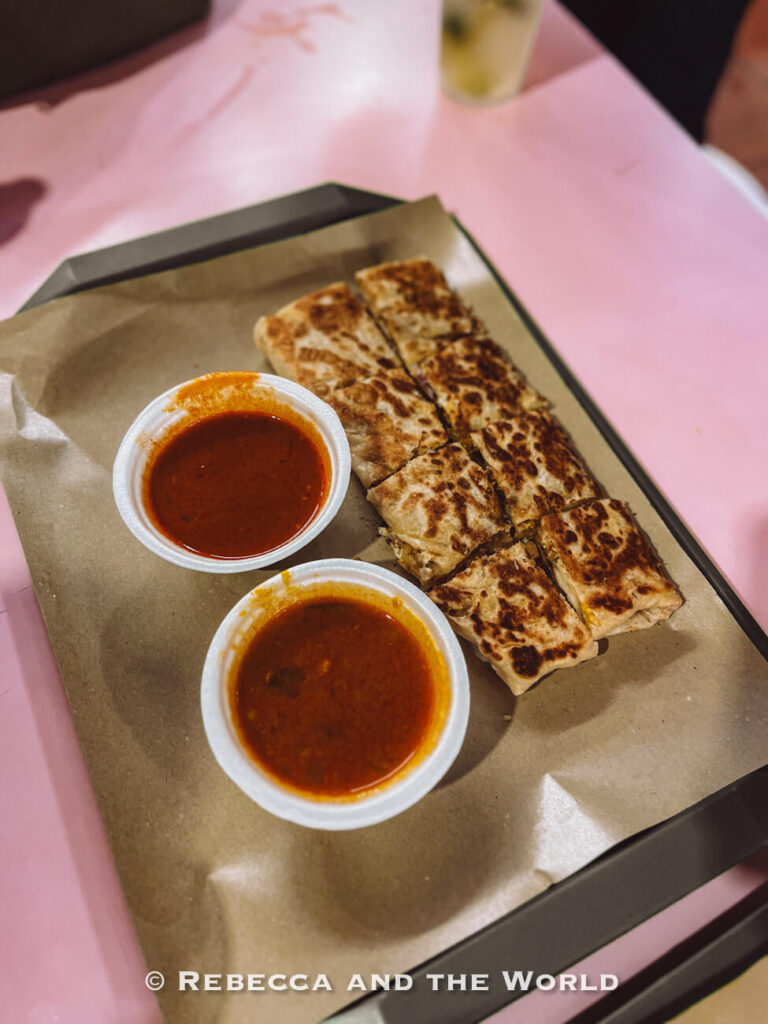 Murtabak sliced into pieces served with two dipping curries, a dish from the Singapore food tour's Little India stop