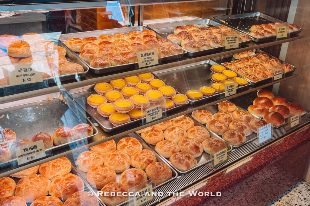 A bakery display case of Cantonese egg tarts and pastries in Chinatown, Singapore