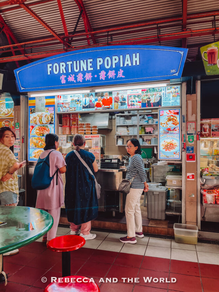 Customers queuing at Fortune Popiah, a hawker stall specialising in popiah, in a Singapore hawker centre