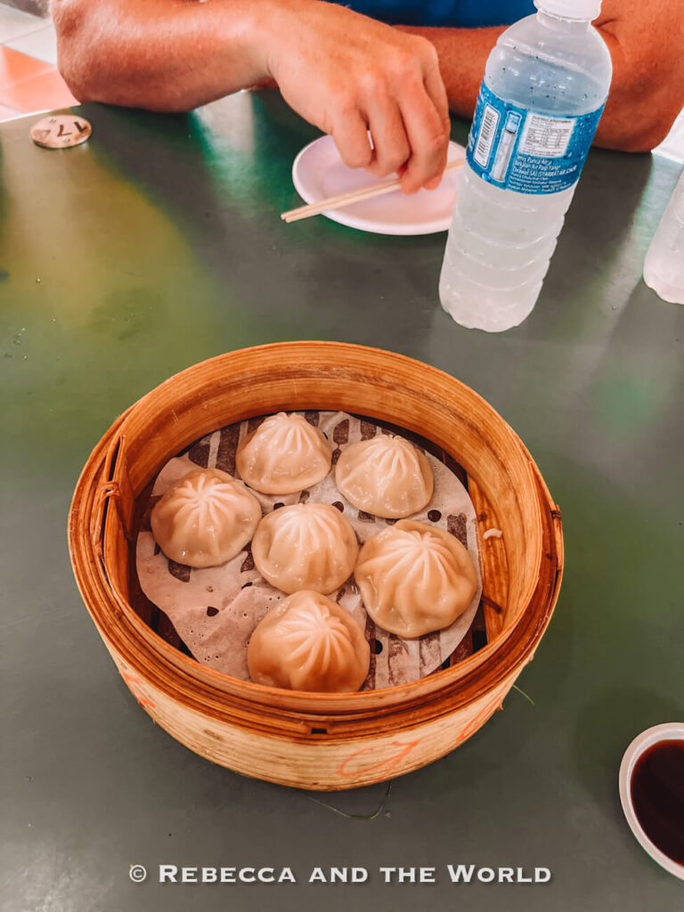 A bamboo steamer of xiao long bao soup dumplings, the first dish on the Singapore chef's food tour