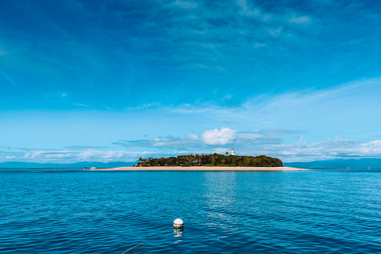 Low Island and lighthouse viewed from the water on a Great Barrier Reef boat trip from Port Douglas