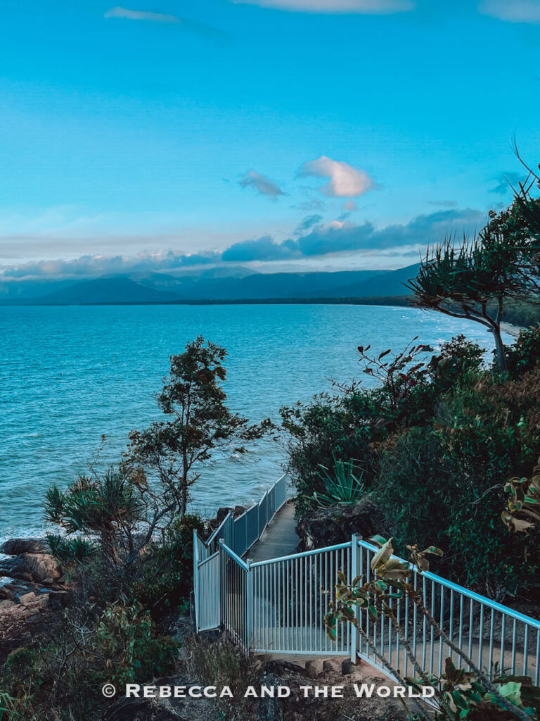 Boardwalk and railing leading down to the ocean at dusk on the Flagstaff Hill lookout walk in Port Douglas, with the coastline stretching into the distance